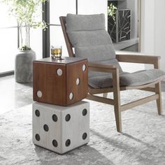 a chair sitting on top of a wooden block next to a table with dices