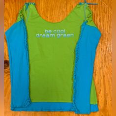 Funky Upcycled Long Sleeve T Shirt. Unknown Designer. Teal And Green Tee With Catchphrase ‘Be Cool Dream Green’ . Measurements In Photos. Equivalent To A Small, Imo. Never Been Worn. Green Cotton Y2k Tank Top, Green Y2k Stretch T-shirt, Blue Organic Cotton T-shirt For Spring, Relaxed Fit Blue Organic Cotton Tops, Blue Relaxed Fit Organic Cotton Tops, Spring Organic Cotton Stretch Tops, Fun Cotton Crew Neck Tank Top, Green Stretch Cotton T-shirt, Blue Cotton Y2k Style Tops