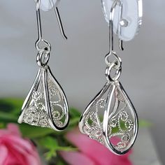 Filigree earrings made by intricate metal work, creating a rich floral and dainty look. The floral silver earrings are inspired by Art nouveau jewelry combined with modern design. These silver long earrings are perfect for a beloved woman, and as a pampering gift for yourself. The earrings are very flattering, comfortable to wear as a jewel for everyday use and impressive as a jewel for a special occasion. The structure of the earrings is of a chunky basket, approximately 20 mm long, creating an elegant and unique style. The earrings are made of 925 sterling silver by hand tools only. Each piece of jewelry is handmade to order, therefor due to the special nature of handcrafting, there may be slight differences compared to the jewelry in the photos shown. This adds to the charm and individu Silver Modern Jewelry, Silver Filigree Jewelry, Nouveau Earrings, Silver Long Earrings, Art Nouveau Earrings, Bijoux Art Nouveau, Art Nouveau Earring, Nouveau Jewelry, Filigree Jewelry