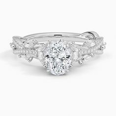 an oval shaped diamond ring with leaves on the band