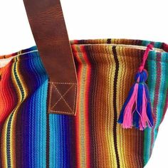 "Our Hacienda Tote bag is made of brightly striped cotton fabric loomed in Guatemala using a traditional foot loom by women artisans. Fully lined with 2 inside pockets, one is a zip pocket. Zip closure at the top with wide leather straps for comfort. * 19\"W x 13\"H / Strap drop - 11\" * Made following Fair Trade guidelines * Handmade in Guatemala" Multicolor Tote Bag With Striped Lining, Everyday Multicolor Shoulder Bag With Weaving Work, Fair Trade Multicolor Tote Shoulder Bag, Multicolor Fair Trade Tote Shoulder Bag, Handwoven Striped Bags For Everyday Use, Everyday Handwoven Striped Bags, Fabric Loom, Sustainable Bag, Boho Tote