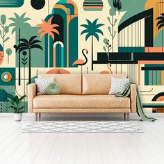 a couch sitting in front of a wall mural with flamingos and palm trees on it