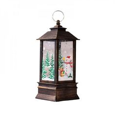 an old fashioned christmas lantern hanging on a white wall with snow and trees in the background