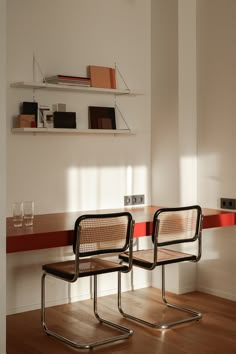 two chairs sitting next to each other on top of a hard wood floored floor