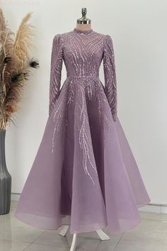 This exquisite formal evening gown is perfect for special occasions. Crafted from high-quality fabric, it features intricate embroidery adding a touch of elegance and sophistication. The long sleeves and flowing skirt create a timeless silhouette that ensures you will look stunning. Whether attending a wedding, gala, or formal event, this gown promises a blend of comfort and style, making you the center of attention Embellished Long Sleeve Ball Gown For Prom, Elegant Long Sleeve Sequined Ball Gown, Fitted Long Sleeve Ball Gown For Gala, Elegant Embroidered Gown For Banquet, Elegant Embroidered Banquet Gown, Elegant Embroidered Evening Dress For Prom, Sequin Long Sleeve Gown For Banquet, Elegant Long Sleeve Ball Gown, Long Sleeve Sequin Gown For Banquets