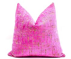 a bright pink pillow with gold speckles on the front and back, against a white background