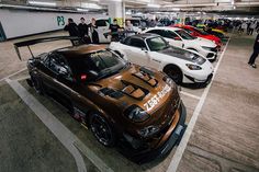 there are many cars that are parked in the parking garages and people standing around