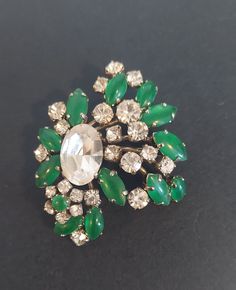 This vintage green and clear crystal brooch is not marked. The Mantessa tag was on this brooch when purchased. Antique Green Brooch For Evening, Vintage Green Brooch For Evening, Vintage Green Brooch For Formal Occasion, Green Vintage Brooch For Formal Occasions, Vintage Green Brooches For Formal Occasions, Vintage Green Evening Brooches, Vintage Green Evening Brooch, Vintage Green Brooch Jewelry, Green Jeweled Brooch Gift