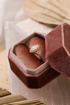 an open ring box sitting on top of a table