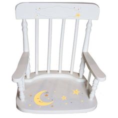 a white rocking chair with stars and a moon painted on the back side, sitting in front of a white background