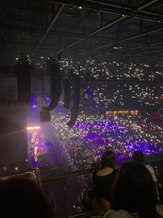 a large crowd at a concert in the dark