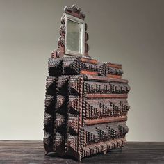 a stack of bricks with a mirror on top