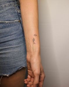 a woman with a small tattoo on her arm