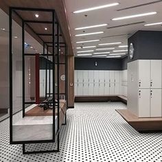 an empty locker room with white and black walls