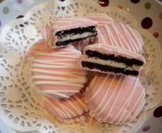 some pink and white striped cookies on a plate