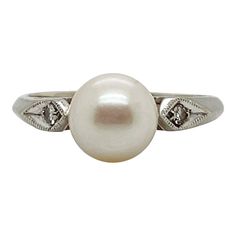 A fine Retro signed pearl cocktail ring.  In 14k white gold.  Set with 7mm round white pearl and flanked by two small accent diamonds on the shoulder of the setting.  Marked to the shank for Rothman & Schneider of New York City.  Simply a wonderful Mid-Century ring!  Date: Mid-20th Century  Overall Condition: It is in overall good, as-pictured, used estate condition with some fine & light surface scratches and other signs of expected light wear consistent with age.  Fineness: Marked 14k for gold Pearl Cocktail Ring, Mabe Pearl, White Gold Set, Gold Cocktail Ring, Gold Cocktail, Maker's Mark, Pearl Diamond, Gold Set, Gold Pearl