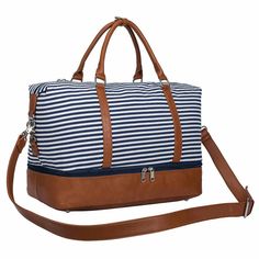 a blue and white striped duffel bag with brown leather handles on the bottom strap