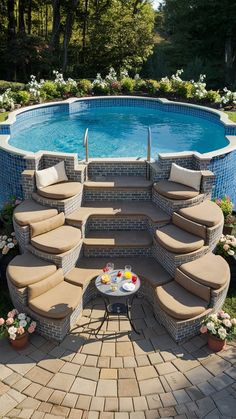 an outdoor pool with steps leading up to it and seating area next to the pool