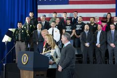 a woman standing at a podium in front of a group of uniformed men and women