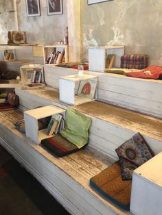 there are many books on the shelves in this room and one has a bag sitting on it