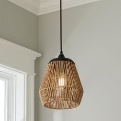 a light that is hanging from the ceiling in a room with gray walls and white trim