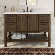 a bathroom vanity with two mirrors above it and towels on the counter top next to it