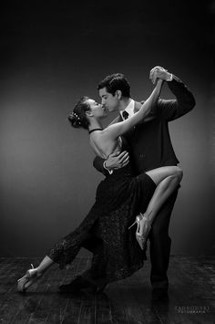 a man and woman are dancing together on the dance floor in black and white photo