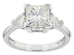 Pre-Owned Moissanite Fire® 2.56ctw diamond equivalent weight square brilliant and heart shape, Platineve® ring. Measures 5/16" L x 1/16" W and is not sizeable. Actual moissanite weight is 2.30ctw. Comes with certificate of authenticity..  This product may be a customer return, vendor sample, or on-air display and is not in its originally manufactured condition.  It may not be new.  In some instances, these items are repackaged by JTV. Gia Certified Trillion Cut Diamond Ring, Gia Certified Trillion Cut Cubic Zirconia Ring, White Moissanite Diamond Ring With Heart Cut, Gia Certified Heart Cut Diamond Ring, White Square Cut Moissanite Wedding Rings, White Heart Cut Moissanite Diamond Ring, White Square Cut Moissanite Ring, Classic Trillion Cut Diamond Ring Gia Certified, Moissanite Square Cut Brilliant Diamond Ring