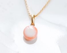 The simple pendant necklace features Rare to get Japanese genuine pink coral pendant ( color is orangish pink and white) is hung from cable chain. All of material is Made in Japan 18k solid gold, backside is attached clover plate. Japanese coral is valuable these days. These coral is gathered at off coast of Kouchi prefecture in Japan. Japanese coral has a white line through the center like a human bone so that these coral has white color. High quality ,never been dyed or enhance the color. A ti Pink Cable Chain Necklace Gift, Pink Cable Chain Necklace For Gift, Pink Cable Chain Necklace As Gift, Orange Round Pendant Necklace, Modern Orange Necklace As Gift, Delicate Peach Jewelry For Gifts, Modern Orange Necklace For Gift, Modern White Necklace With Cable Chain, Minimalist Pink Pendant Necklace