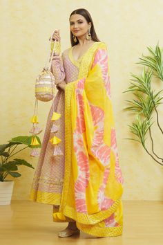 Yellow angarkha style printed anarkali with embroidered cuffs and side tassles. Paired with an embroidered pant, dupatta and a potli bag.
Components: 4
Pattern: Embroidered
Type Of Work: Gota
Neckline: V Neck
Sleeve Type: Long
Fabric: Cotton
Color: Yellow
Other Details: 
Side tassles
Dual-toned dupatta
Closure: 
Pant: Front drawstring tie-up
Occasion: Puja - Aza Fashions Lace Anarkali, Kalidar Kurta, Anarkali Designs, Embroidered Cuffs, Pink Anarkali, Printed Anarkali, Embroidered Anarkali, Potli Bag, Long Kurti Designs