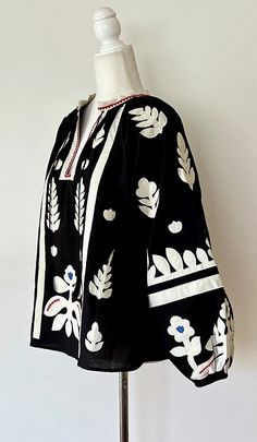 Join us in welcoming our first Ukranian designer. This gorgeous "Boho" appliqued and embroidered blouse is a knock-out. Material is high quality cotton blend, nice weight and touch. Round small white tab neck and open placket are subtlely accented in red. Easy fit peasant cut. Full long cuffed sleeves. Front and back panels appliqued and embroidered in a clean art deco floral motiff. The pattern effectively uses the black background to highlight the beauty of the appliques. Dramatic, yet classic Clean Art, Print Design Trends, Embroidery Fashion Detail, Wearable Art Clothing, Kaftan Designs, Silk Scarf Style, Art Deco Floral, Versace Fashion, Perfect Blouse