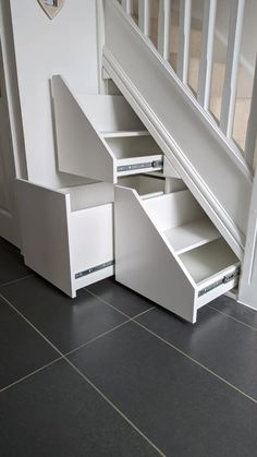 an under stairs storage unit with drawers underneath