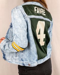 Support your favorite team in style with our Jersey Denim Jackets. Each jacket is One-Of-A-Kind. If you have a jersey that you would like to have transformed into one of these jackets, please contact us! This piece was upcycled from pre-loved clothes. Each item we sell has maintained it's quality, but any small imperfection will be pictured. Model is 5'4 and wears a size 4 top. Shirt Upcycle Diy, Jean Jacket Diy, Football Drip, Ropa Upcycling, Jacket Art, Diy Pants, Upcycled Denim Jacket, Diy Denim Jacket, Custom Leather Jackets