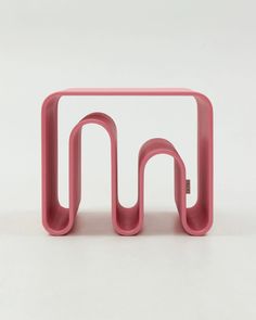 a pink table with two curved sections on it's sides and the top section is made out of plastic