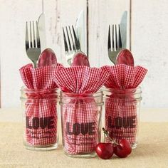 three jars with forks and two cherries in them, one has a red checkered bow