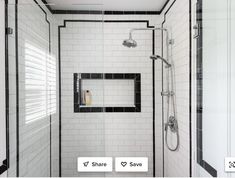 a walk in shower with black and white tile on the walls, along with an open window