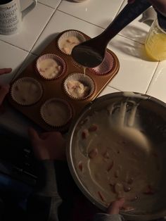 a pan filled with muffins sitting on top of a counter next to a cupcake tin