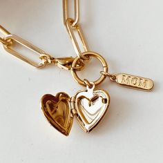 18k Gold Paperclip Style chain with a 18K Gold Heart locket and a dainty mom tag. Yellow Gold Charms With Adjustable Chain For Gift, Mother's Day Heart Charm Locket Necklace Gift For Mom, Personalized Gold Locket Necklace For Mom, Gold Locket Necklace Gift For Mom, Gold Locket Necklace, Gift For Mom, Mother's Day Locket Necklace With Charms, Gold Locket Necklace For Mom, Mother's Day Yellow Gold Heart Charm Locket Necklace, Gold Locket Charm For Gifts