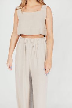 The Christy Top is the epitome of contemporary femininity. From its soft linen-blend fabric to its flattering neckline and cropped silhouette, this top offers premium-quality details. It's a stunning choice paired with the Samantha Maxi Skirt, or style it with white trousers or your favorite denim. Available in two colorways. FIT: Runs true to size. If you are a C-cup or larger, consider that this top is significantly cropped. MODEL: Model is 5’7” / wearing a small. MATERIAL: 55% Linen, 45% Rayon. GARMENT DETAILS: Premium quality linen-blend dressy tank. Features a square neckline, wide shoulder straps, and a cropped silhouette. SIZE GUIDE: XS (00-2) / S (2-4) / M (6-8) / L (10-12) Garment Details, White Trousers, C Cup, Sleeveless Crop Top, Cropped Top, Square Neckline, Linen Blend, Shoulder Straps, Size Guide