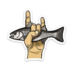 a hand holding a fish in the middle of it's fingers and pointing to it