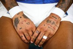 a person with tattoos on their hands