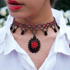 "Here is a choker that is truly captivating - a masterpiece that effortlessly combines the vintage allure of yesteryears with a touch of modern elegance. Behold, the centerpiece of this conversation: a Gothic-style choker that beckons with its unique charm. Picture a red rose, vivid and striking, set against an enigmatic black background, forming an intricate cameo. This captivating piece is cradled within a gunmetal setting, designed to mesmerize anyone who sets their gaze upon it. What sets th Vintage Red Choker Jewelry, Red Vintage Choker Jewelry, Vintage Red Choker For Party, Vintage Red Choker Necklace, Red Vintage Choker Necklace, Party Choker Necklace With Rose Design, Vintage Choker Jewelry For Valentine's Day, Vintage Choker As Valentine's Day Gift, Handmade Red Vintage Choker