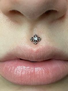 a woman's nose has a small diamond on it