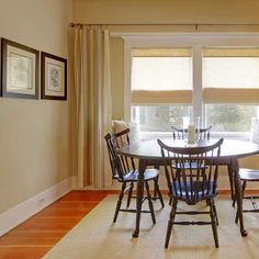 a dinning room table and chairs in front of a window