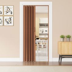 an open door leading to a kitchen and dining room with artwork on the wall behind it