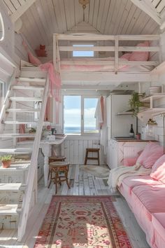 a pink couch sitting under a loft bed next to a stair case in a room