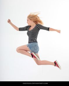 a woman jumping in the air with her legs spread