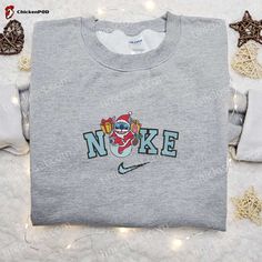 Introducing the limited edition Nike Christmas x Stitch Santa Embroidered Sweatshirt, a must-have for Disney fans and fashion enthusiasts alike! This sweatshirt features a unique and intricate embroidery of Stitch dressed as Santa, adding a touch of whimsy to your holiday wardrobe. The high-quality materials ensure comfort and durability, making it perfect for both indoor [...] Nike Cartoon, Disney Character Shirts, Nike Inspired, Best Family Gifts, Cindy Lou, Limited Edition Shirt, Cartoon Sweatshirts, Merry Christmas Shirts, Jason Voorhees