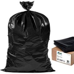 a black trash bag next to a cardboard box