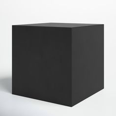 a black cube sitting on top of a white floor